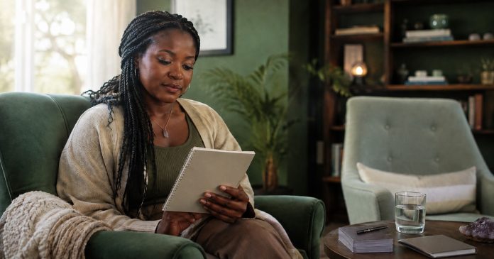 AI-created editorial illustration; corrected natural screen and reading-material orientation. A thoughtful adult woman with dark skin and braided hair reviewing a checklist after a spiritual consultation, seated in an airy sage-green lounge